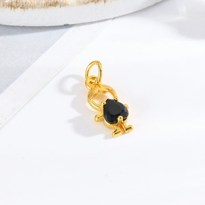 Detail shot of a gold girl figurine pendant with a heart black gemstone inlay for DIY