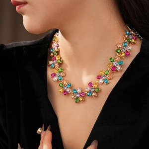 Close-up of vintage golden necklace with colorful rhinestone floral pattern on neck