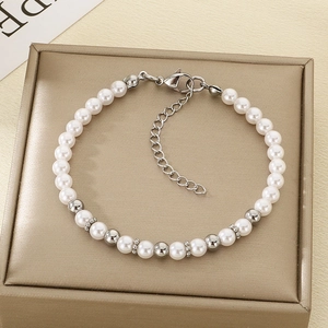 Close-up of pearl and stainless steel bead bracelet with adjustable lobster clasp