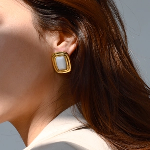 Vintage style gold stainless steel rectangular stud earrings with white stone on model