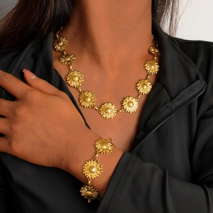 Detailed view of 18K gold plated sunflower necklace and bracelet set on a female model