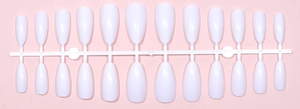 Flat lay of 24 white glossy almond-shaped press-on nail tips on a central plastic rack