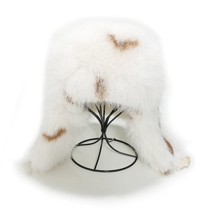 Close-up of white and brown faux fox fur trapper hat with thick plush lining detail