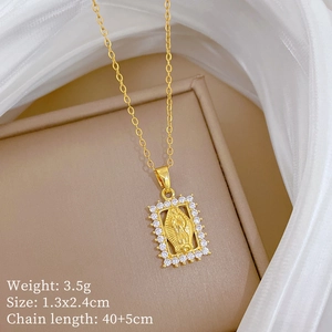 Detailed view of gold moon pendant with Virgin Mary relief and zircon inlay on necklace