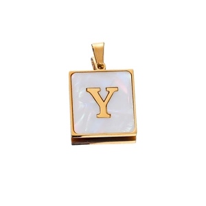 Detail shot of a square 22mm golden stainless steel pendant with letter Y on white shell