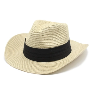 Close-up of beige woven straw hat texture with a wide black ribbon trim and curved brim