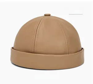 Detailed close-up of beige PU leather docker hat showing premium stitching and texture