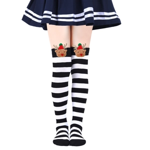 Close-up of knee-high Christmas socks with 3D reindeer dolls and black-white stripes