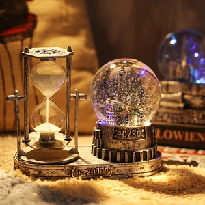 Vintage hourglass crystal ball with LED lights and castle model in silver finish