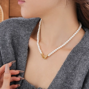Detail of elegant vintage oval pearl necklace with zircon accents for women's fashion