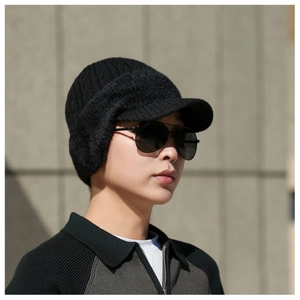 Detail of men's winter knit earflap hat with brim showing warm thick wool texture