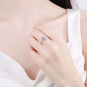 Elegant S925 sterling silver emerald cut moissanite ring with pavé diamonds on finger