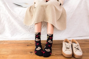 Detail of cotton crew socks with a brown bear, red heart, and Love Me text pattern