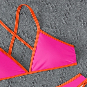 Close-up of pink and orange contrast bikini top showing stitching and strap detail