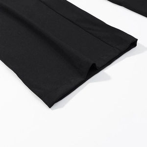 Close-up of black high-waisted trousers featuring reinforced double-stitch hem and twill fabric