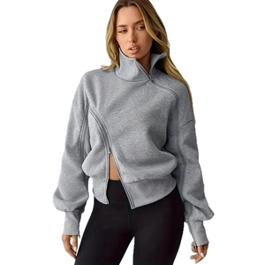 Detail of the gray women's sweatshirt showing the asymmetric zipper and high stand collar