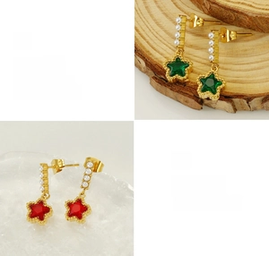 Macro detail of star-shaped earrings with colorful gemstones and white faux pearls