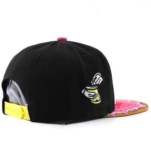 Detail of flat brim baseball cap showing side embroidery and yellow snapback closure