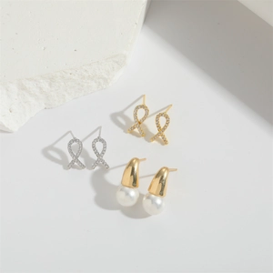 Baroque bow earrings and pearl drop studs in gold and silver finish with sparkling rhinestones