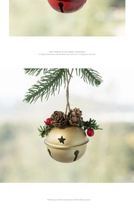Close-up of golden Christmas bell with star cutouts, pine cones and red berries on pine