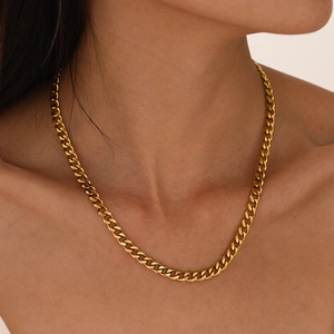 Minimalist gold plated stainless steel Cuban link necklace worn by a female model