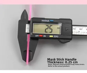 Macro shot of 13cm pink plastic facial mask spatula showing handle thickness of 0.25cm