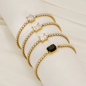 Detailed macro view of four stainless steel tennis bracelets with black and white zircons