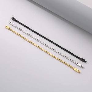 Detailed view of woven dragon bone link bracelets in black, silver, and gold finishes