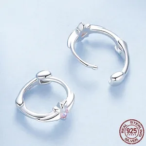 925 sterling silver star hoop earrings with small pink zircon on light blue background