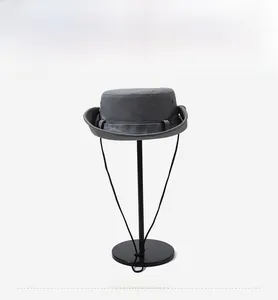 Front view of grey outdoor sun hat with wide brim, adjustable wind cord and side air vents