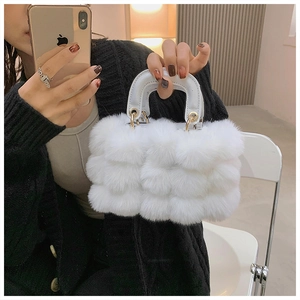 Close-up of white plush handbag featuring fluffy texture and soft handle detail