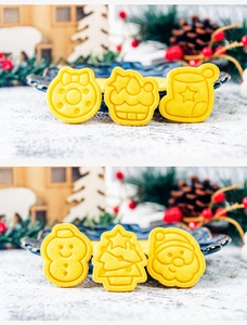 Detail of six yellow Christmas cookie molds including Santa, tree and snowman shapes