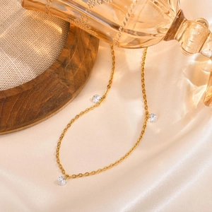 Elegant gold stainless steel necklace featuring three clear zircon pendants on a fine chain