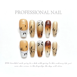 Handmade Chinese style press-on nails with amber gradient and bamboo art designs