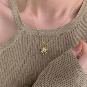 Elegant 925 sterling silver gold-plated sunburst star pendant necklace on a model