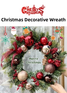 Close-up of 40cm Christmas wreath with red berries and golden ornaments held by hand