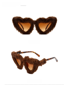 Detail view of heart-shaped sunglasses featuring brown plush frames and orange lenses