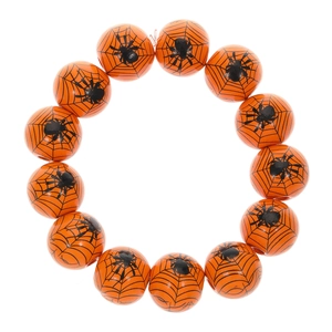 Bracelet d'Halloween avec perles orange et motifs d'araignée et de toile noirs sur fond blanc