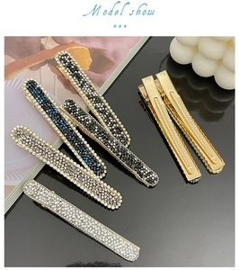Detail of elegant sparkling rhinestone hair clips with golden metal base in various colors