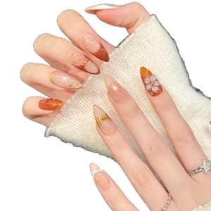 Elegant long stiletto press-on nails with amber gradient, 3D floral art and gold accents