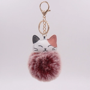 Cute cartoon cat plush keychain with a burgundy pompom and golden metal clasp for bags