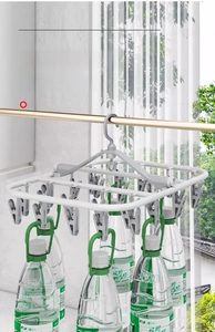 Detail showing high load capacity of white multi-clip drying rack holding heavy water bottles