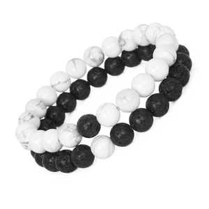 Close-up of 8mm white turquoise and black lava stone beads on elastic bracelets