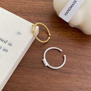 Minimalist S925 sterling silver twist open rings with rectangle zircon on wood surface