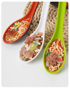 Detailed view of realistic miniature ramen soup with eggs and meat in ceramic spoons