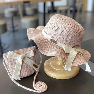 Pink straw sun hat and matching bag set with cream ribbon bows for toddler girls