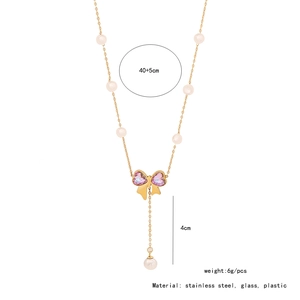 Detail of pink bow and pearl necklace with dimensions 40+5cm length and stainless steel specs