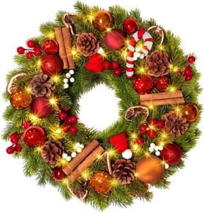 Detail of Christmas wreath with pine cones, cinnamon sticks, berries and warm LED lights