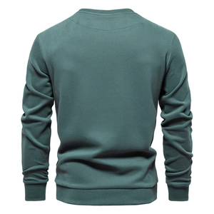 Rear view of dark green crew neck sweatshirt with ribbed cuffs and hemline detail