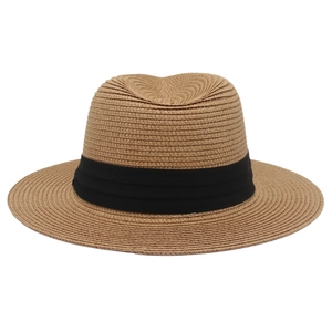 Close-up of woven panama hat texture with a triple-pleated black ribbon band